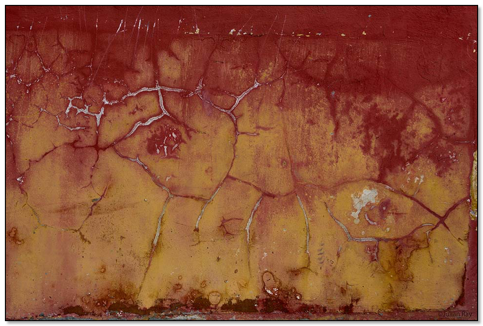 red cracks in a yellow wall